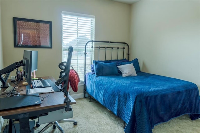 carpeted bedroom featuring baseboards