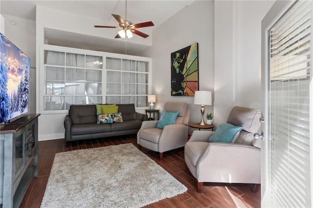 living room featuring baseboards, a ceiling fan, and wood tiled floor