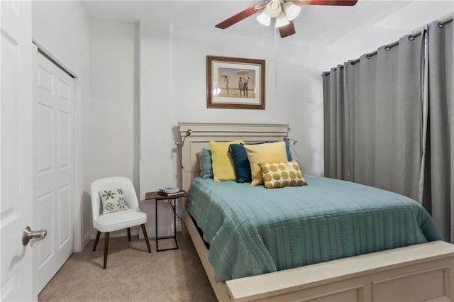 bedroom featuring a ceiling fan and light colored carpet