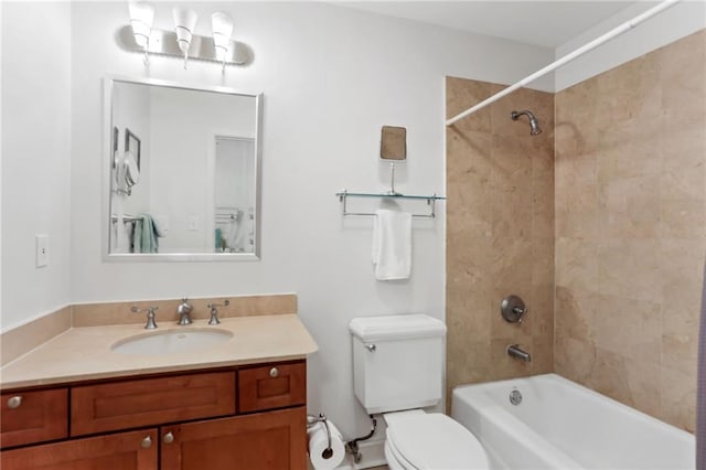 bathroom with washtub / shower combination, vanity, and toilet