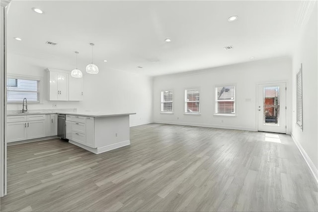 3507 Danneel St, New Orleans, LA 70115 - kitchen with a peninsula, open floor plan, light wood-type flooring, stainless steel dishwasher, and recessed lighting