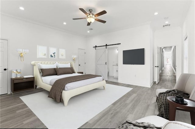 3507 Danneel St, New Orleans, LA 70115 - bedroom featuring a barn door, light wood-style flooring, ornamental molding, recessed lighting, and baseboards