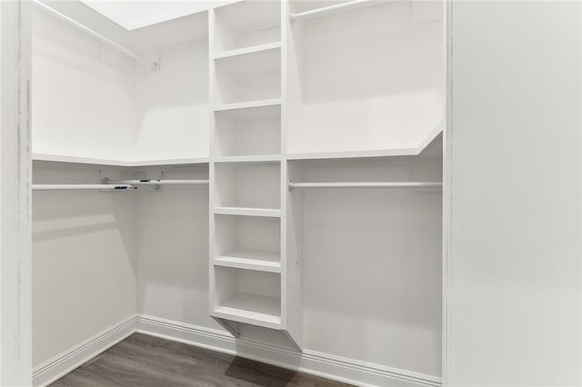 walk in closet with wood finished floors