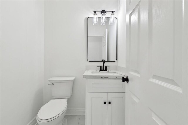 3507 Danneel St, New Orleans, LA 70115 - bathroom featuring vanity, toilet, baseboards, and marble finish flooring