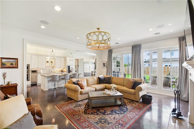 living area with crown molding, a notable chandelier, recessed lighting, and visible vents