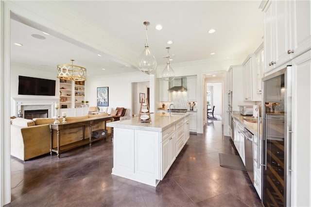 kitchen featuring crown molding, wall chimney range hood, and open floor plan