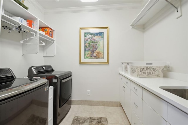 washroom featuring light tile patterned floors, baseboards, cabinet space, separate washer and dryer, and ornamental molding