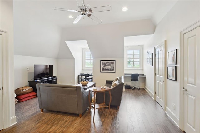 living room with baseboards, wood finished floors, a ceiling fan, and vaulted ceiling