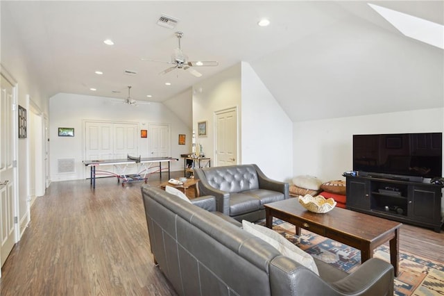 living area featuring vaulted ceiling, recessed lighting, wood finished floors, and visible vents