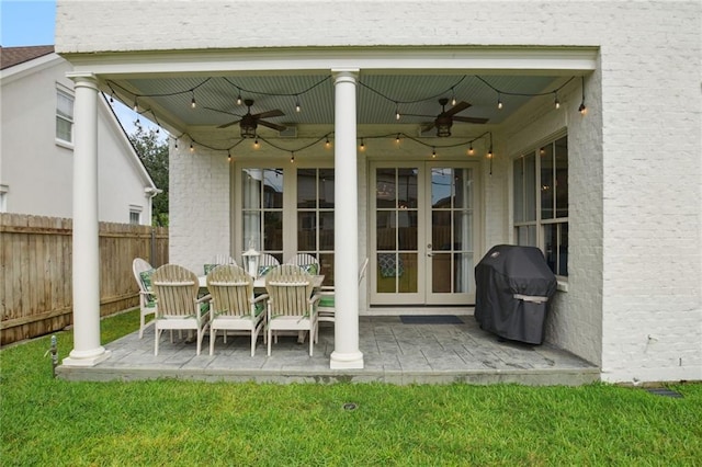 view of patio / terrace featuring a ceiling fan, fence, french doors, and a grill