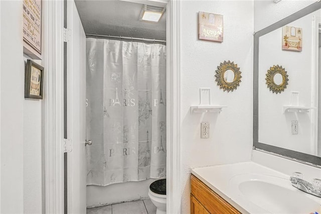 full bath with vanity, shower / bath combo with shower curtain, tile patterned flooring, and toilet