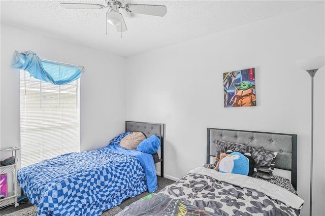 bedroom with carpet floors, ceiling fan, a textured ceiling, and baseboards