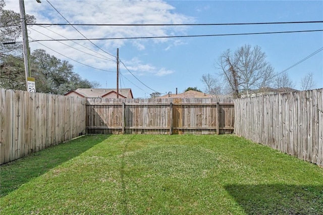 view of yard with a fenced backyard