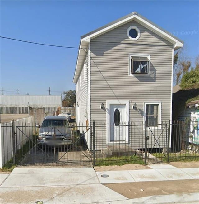 view of front facade with a fenced front yard and a gate