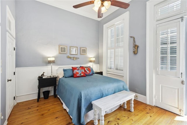 421 Burgundy St Unit 1, New Orleans, LA 70112 - bedroom featuring wood-type flooring, a ceiling fan, and baseboards