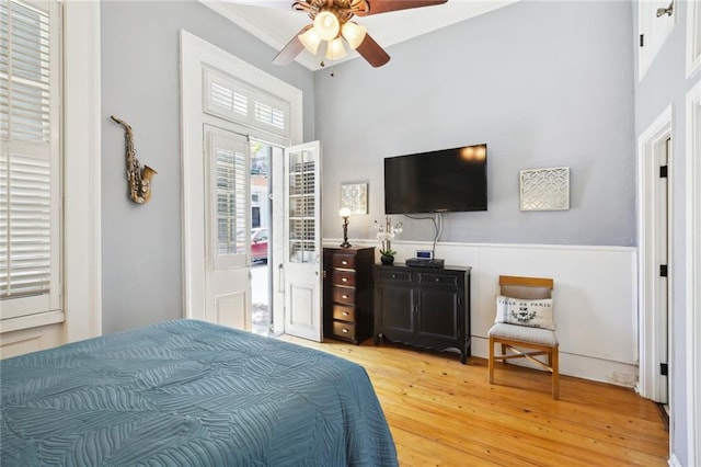 421 Burgundy St Unit 1, New Orleans, LA 70112 - bedroom featuring light wood-style floors, a ceiling fan, and a towering ceiling