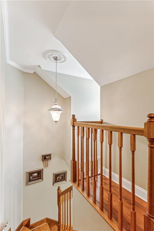 stairs featuring baseboards and vaulted ceiling