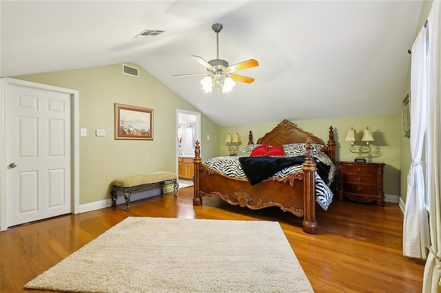 bedroom featuring lofted ceiling, wood finished floors, and visible vents