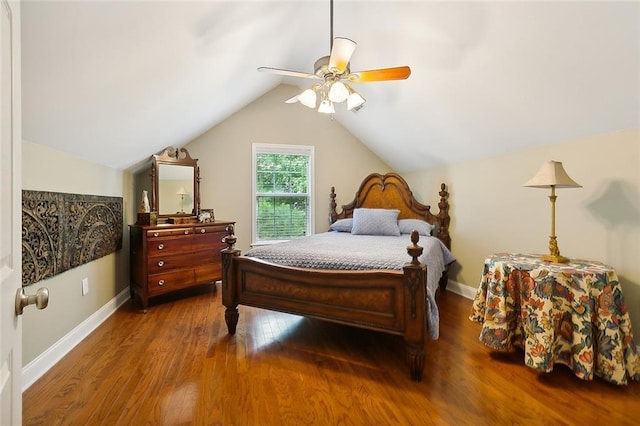 bedroom with lofted ceiling, wood finished floors, baseboards, and ceiling fan