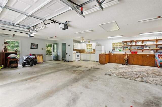 garage featuring a garage door opener and freestanding refrigerator