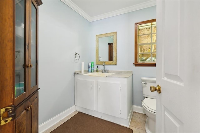 bathroom with baseboards, vanity, toilet, and crown molding