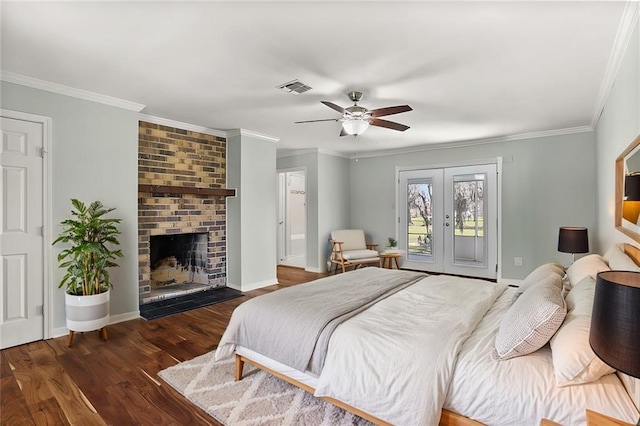 bedroom with a fireplace, wood finished floors, visible vents, access to exterior, and french doors