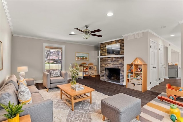 living room featuring crown molding, a fireplace, and wood finished floors