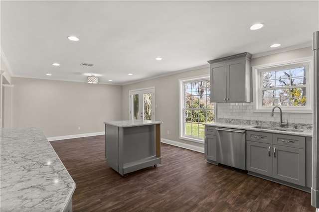 kitchen featuring gray cabinets, backsplash, ornamental molding, a sink, and dishwasher