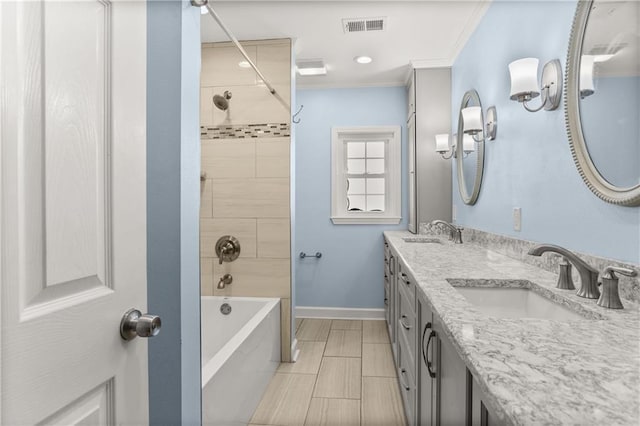 bathroom featuring baseboards, crown molding, visible vents, and a sink