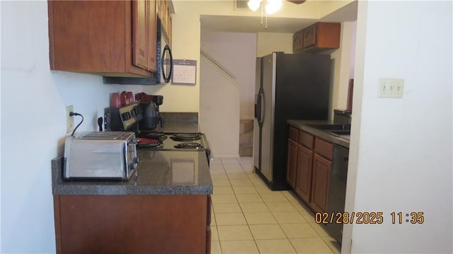 227 Plimsol Ct Unit 227, Slidell, LA 70460 - kitchen with dark countertops, light tile patterned flooring, black microwave, and a ceiling fan