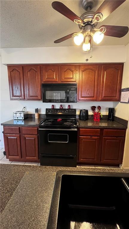 227 Plimsol Ct Unit 227, Slidell, LA 70460 - kitchen with black appliances, dark countertops, ceiling fan, and a textured ceiling