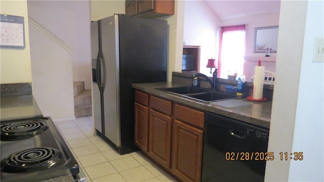 227 Plimsol Ct Unit 227, Slidell, LA 70460 - kitchen with black dishwasher, stainless steel fridge, range, light tile patterned floors, and dark countertops