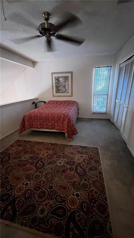 bedroom featuring beam ceiling, carpet flooring, ceiling fan, and a textured ceiling