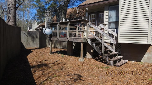 wooden terrace featuring fence