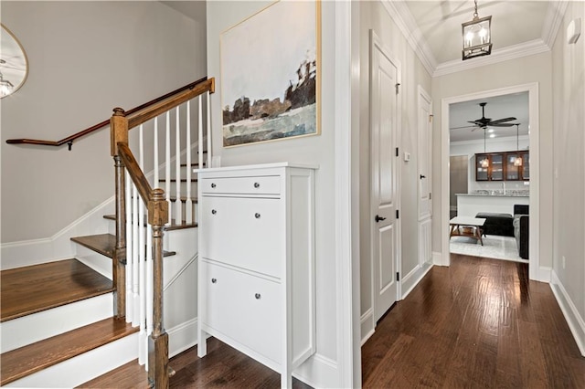 interior space with dark wood-style floors, crown molding, stairway, and an inviting chandelier