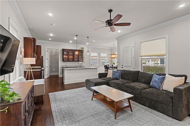 living room featuring dark wood-style flooring, recessed lighting, visible vents, and crown molding