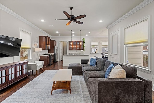 living area featuring dark wood-style floors, ornamental molding, a ceiling fan, and recessed lighting