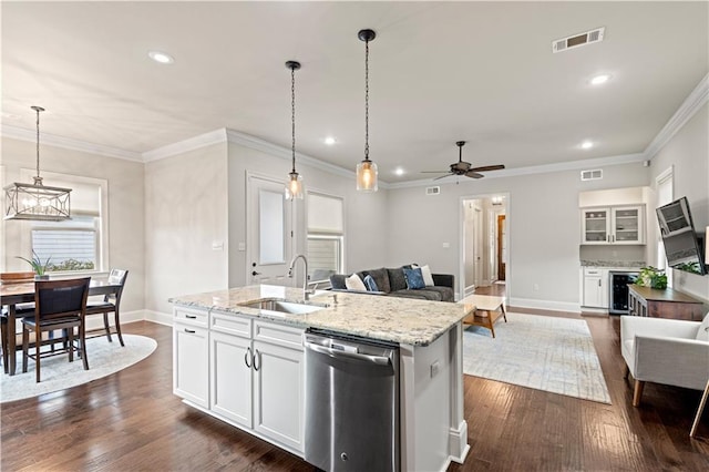 kitchen featuring dark wood-style flooring, a sink, visible vents, open floor plan, and dishwasher