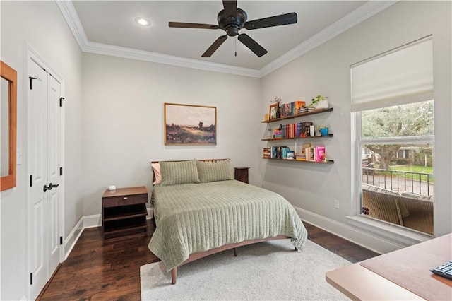 bedroom featuring ornamental molding, wood finished floors, and baseboards