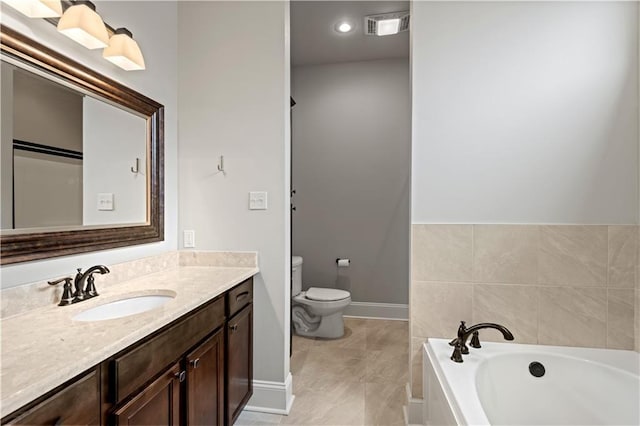 full bathroom with toilet, visible vents, vanity, baseboards, and a bath