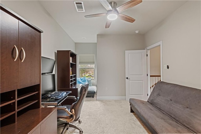 carpeted home office featuring ceiling fan, visible vents, and baseboards