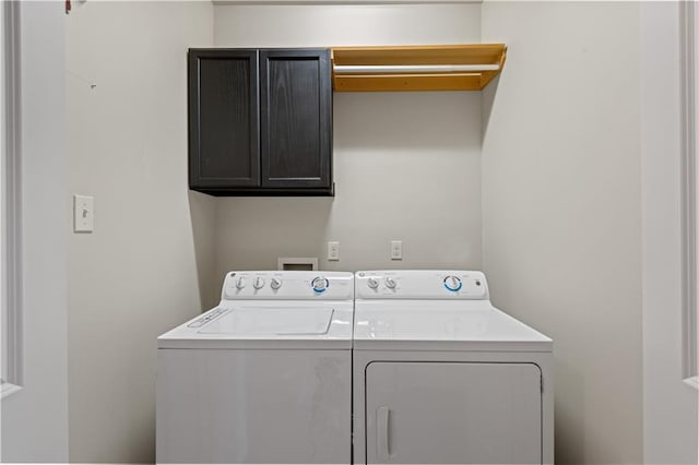 clothes washing area with cabinet space and washing machine and clothes dryer