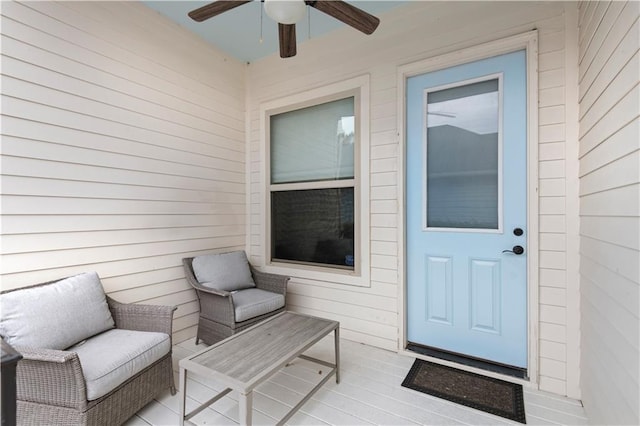 entrance to property with a ceiling fan and outdoor lounge area