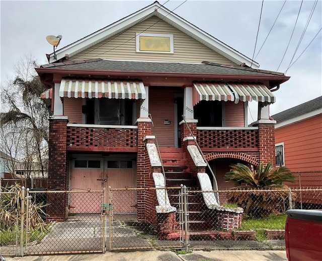 2909 1st St, New Orleans, LA 70113 - view of front of house with a fenced front yard, a garage, roof with shingles, and a gate