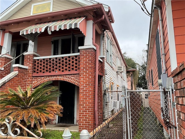 2909 1st St, New Orleans, LA 70113 - view of front of home featuring brick siding, fence, and a gate