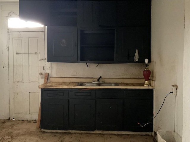 2909 1st St, New Orleans, LA 70113 - kitchen with open shelves, light countertops, and a sink