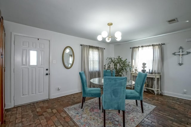 dining space with brick floor, visible vents, a notable chandelier, and baseboards