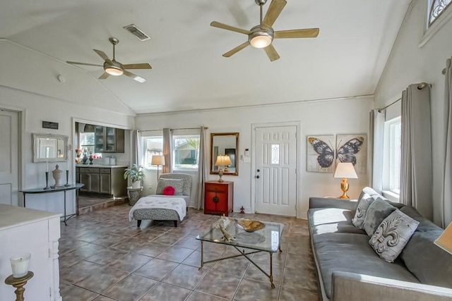 living room with vaulted ceiling, ceiling fan, tile patterned flooring, and visible vents