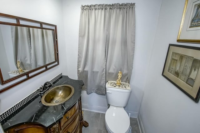 bathroom with toilet, baseboards, and vanity