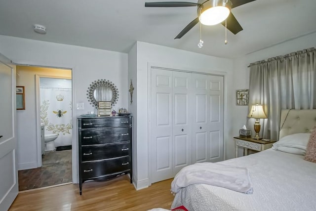 bedroom with a closet, ceiling fan, baseboards, and wood finished floors